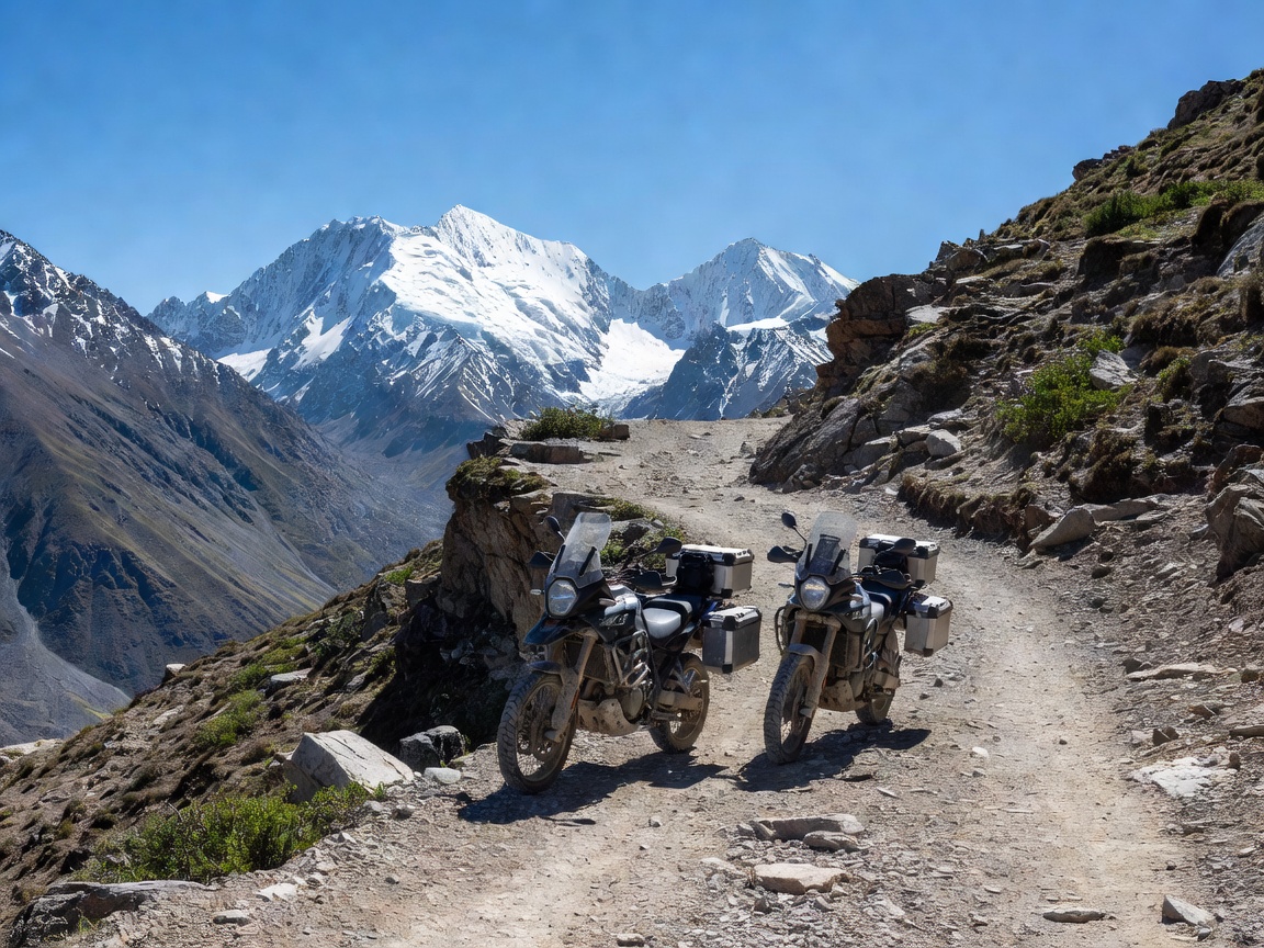 Adventure motorcycles parked on a rugged mountain pass beneath snow-capped peaks
